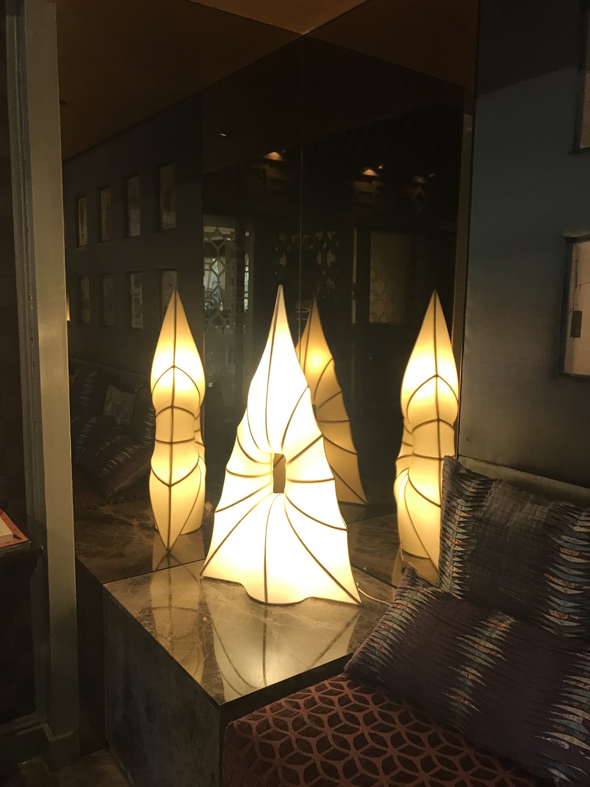 Installed — leaf-form lighting over marble