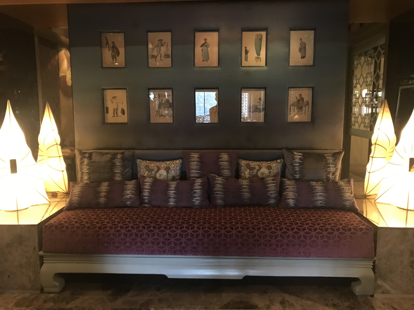 Installed — chinoiserie figure panels and leaf-form lamps