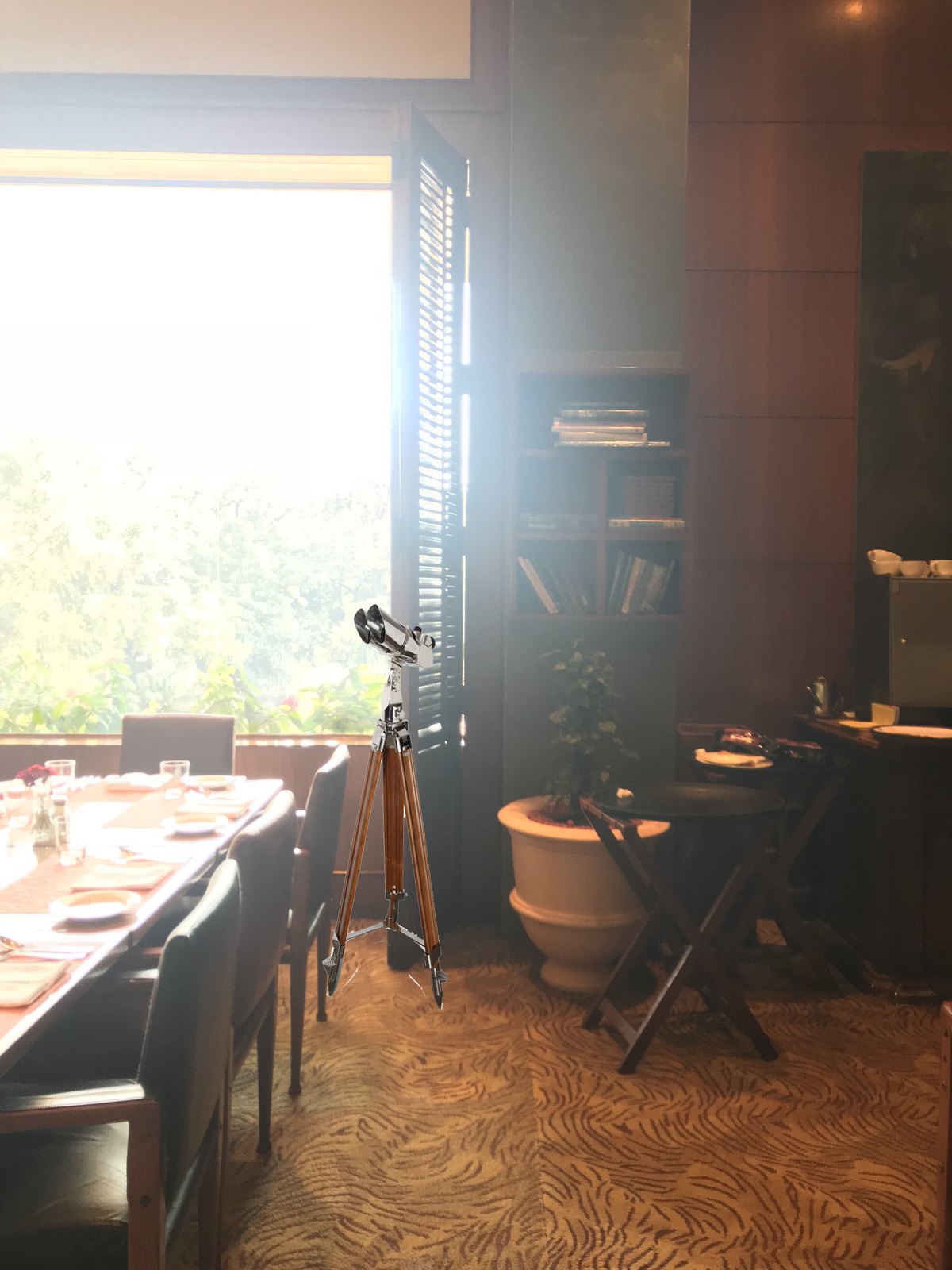 A window treatment with shutters and hung lanterns