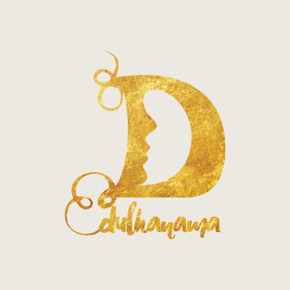 The lettermark in gold on cream